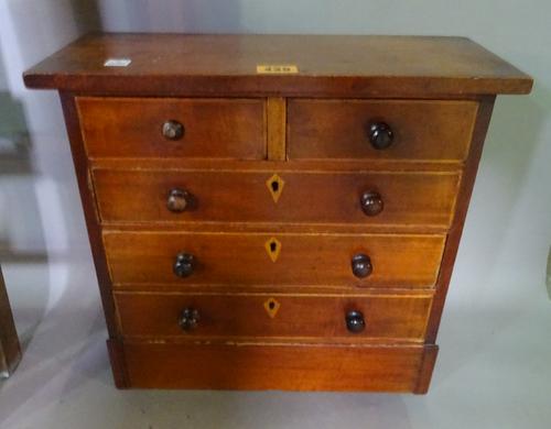 A 19th century miniature chest of two short and three long drawers on plinth base, 39cm wide.  J9
