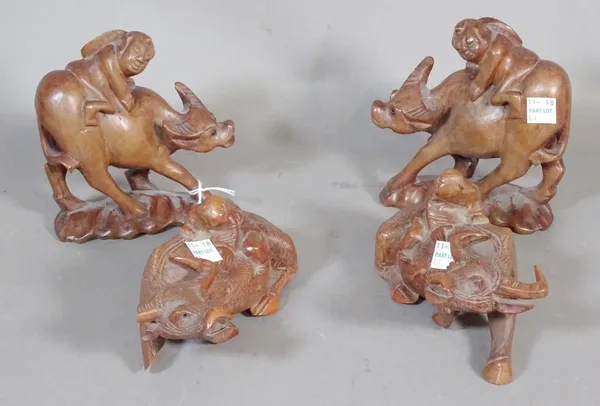 Four Chinese wood figures of boys seated on water buffaloes, 20th century.    CAB