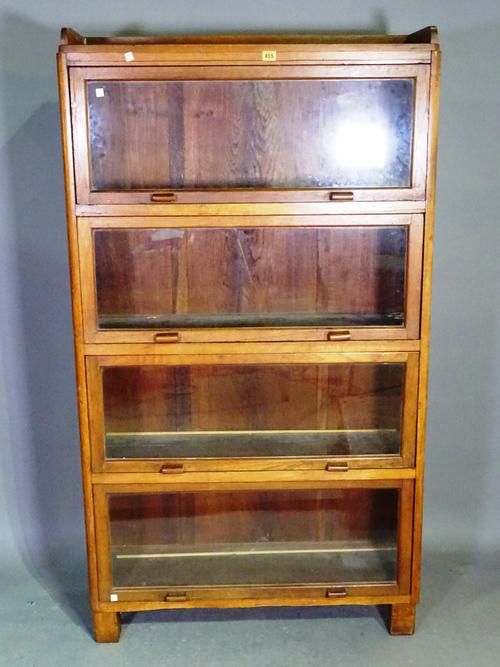 A 20th century oak four section Globe Wernicke, 90cm wide x 164cm high.   BAY 1