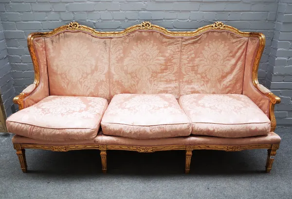 A Louis XVI style gilt framed sofa, with ribbon tied triple hump back, on fluted square supports, 198cm wide x 105cm high.  D3