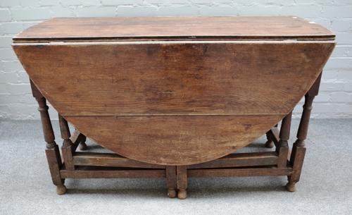 A 17th century oak gateleg dining table on baluster supports united by block stretchers, 47cm wide x 150cm wide open x 74cm high x 122cm across.  J8
