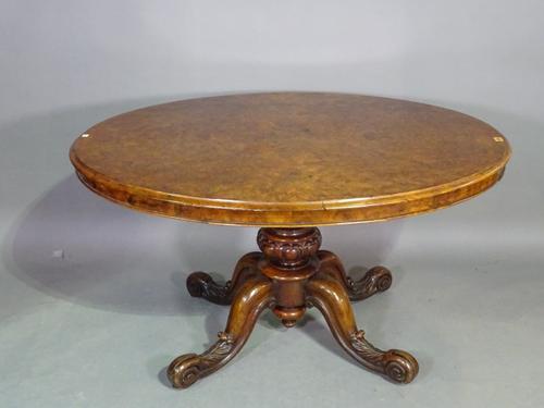 A Victorian figured walnut loo table, the oval snap top on turned column and four scroll supports, 25cm wide x 71cm high x 125cm long.  G9