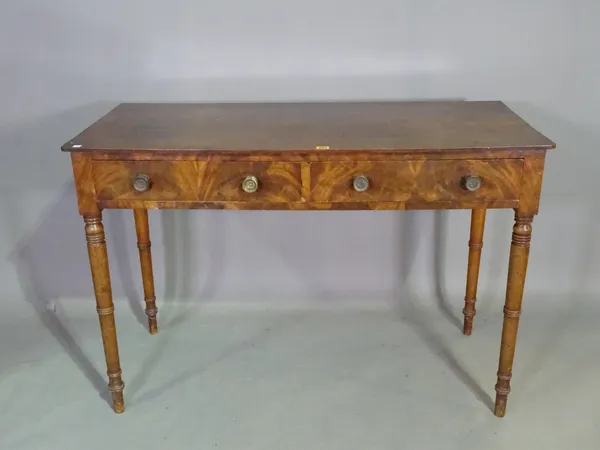 A Regency mahogany rectangular two drawer writing table, on turned supports, 123cm wide x 81cm high x 56cm deep.  J7