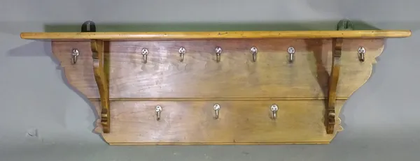 An early 20th century pine wall hanging coat rack, 137cm wide x 40cm high.   A8