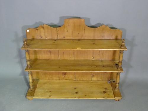 An early 20th century pine three tier open bookcase on bun feet, 103cm wide x 81cm high.  L7
