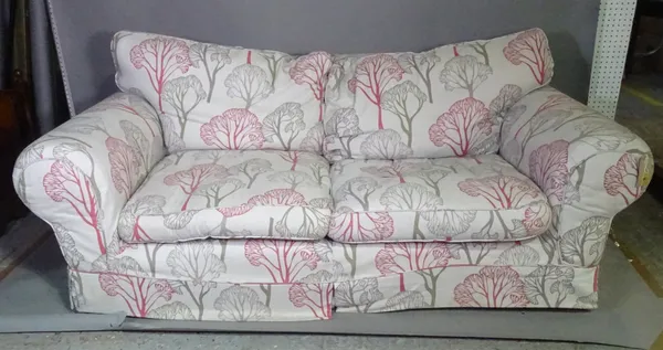 A 20th century three seater sofa with roll over arms and grey and pink foliate upholstery, 210cm wide, and a matching armchair, (2).   I3