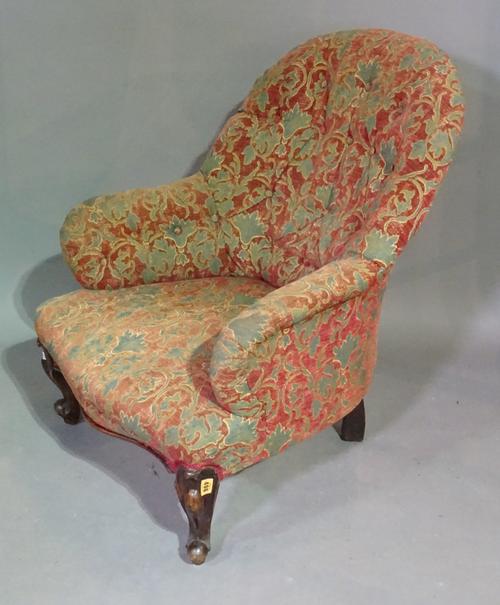 A Victorian mahogany framed low armchair with button back upholstery on scroll supports.   C6