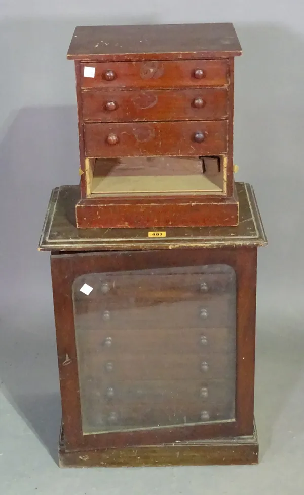 A 19th century mahogany collector's chest with single glass door and seven drawers, 42cm wide x 52cm high, and another miniature chest of four long dr