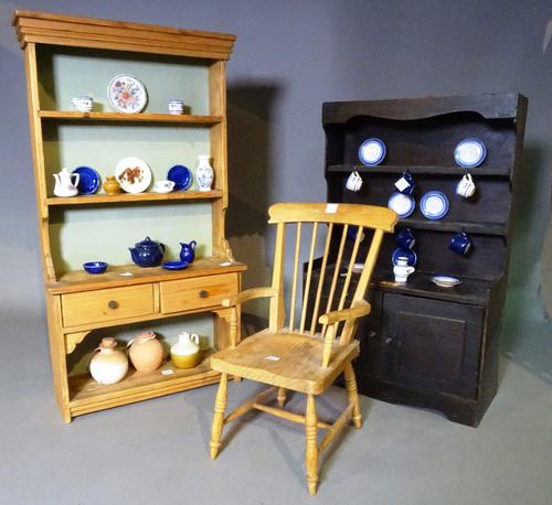 A quantity of miniature furniture comprising; two dressers, 35cm wide x 62cm high, a stickback open armchair, 32cm wide x 52cm high and a quantity of