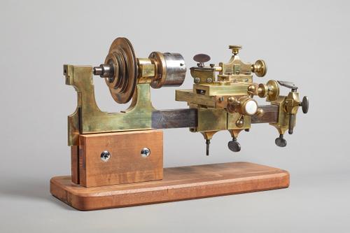 A watchmaker's steel and brass hand-driven latheSecond half 19th CenturyOn later wooden base50cm wide