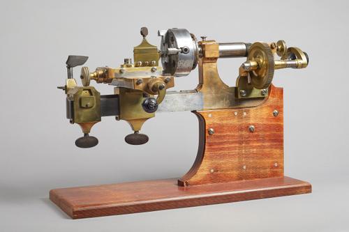 A Brass and steel watchmaker's latheSecond half 19th CenturyThe chuck marked The Cushman Chuck Co. Hartford, Conn. USA, on a later wooden base39cm wid