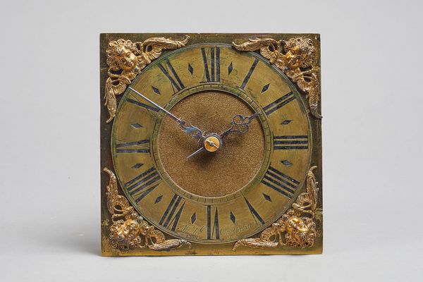 A small James II/Queen Anne weight-driven timepieceBy Michael Cheltenham, LondonThe 6in. square brass dial with cherub head spandrels, brass chapter r