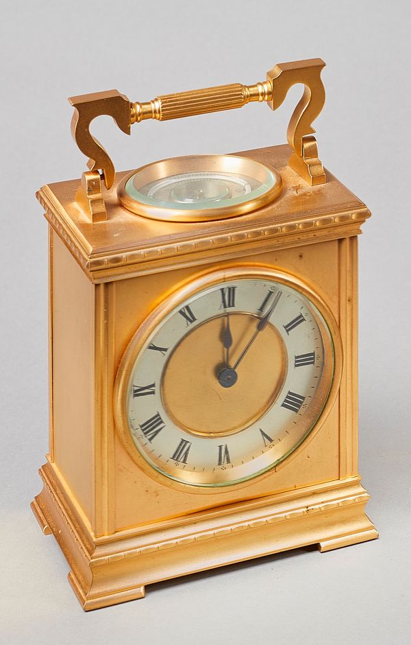 A French gilt brass mantel timepiece with thermometer and compassCirca 1900With shaped fluted handle above a moulded cornice, with glazed bezel, silve