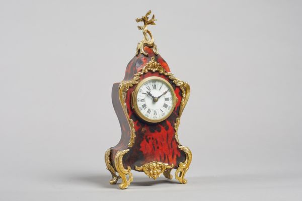 A French giltmetal and tortoiseshell-mounted mantel timepieceIn the Louis XV style, circa 1880The case of shaped outline, surmounted by a foliate spri