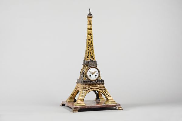 A French Novelty giltmetal, patinated and marble model  of the Eiffel TowerCirca 1880The 3 1/2 in. diameter white enamel dial with Roman numerals, pie