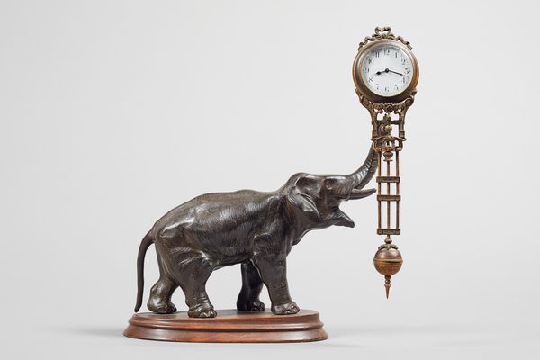A French gilt-brass and patinated metal Elephant swinging pendulum timepieceBy Junghans, circa 1900The timepiece supported from the tip of the elephan