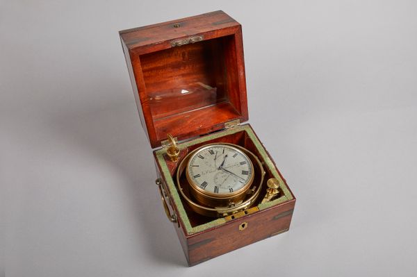 A mahogany brass-bound two-day marine chronometer By John Clarke, Greenock, No. 628, Circa 1840The three-tier case with hinged lid and glazed observat