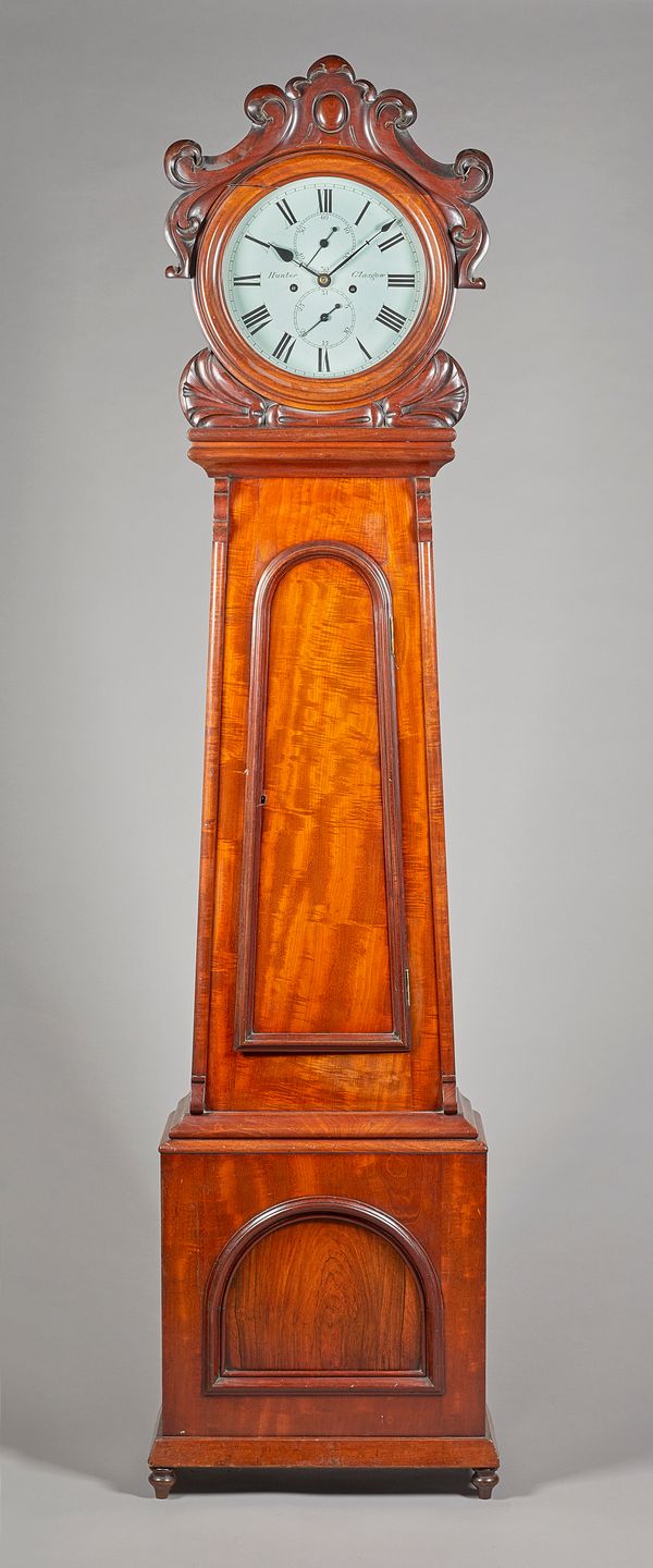 A Victorian Scottish mahogany longcase clockBy Hunter, Glasgow, circa 1850The carved drum-shaped hood with glazed bezel, above tapering trunk inset wi