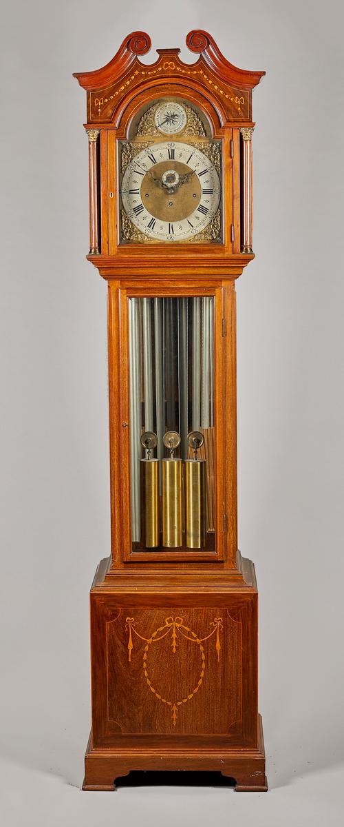 A giltmetal-mounted mahogany, marquetry and boxwood-outlined tube quarter-chiming longcase clockCirca 1920The case with a swan neck pediment inlaid wi