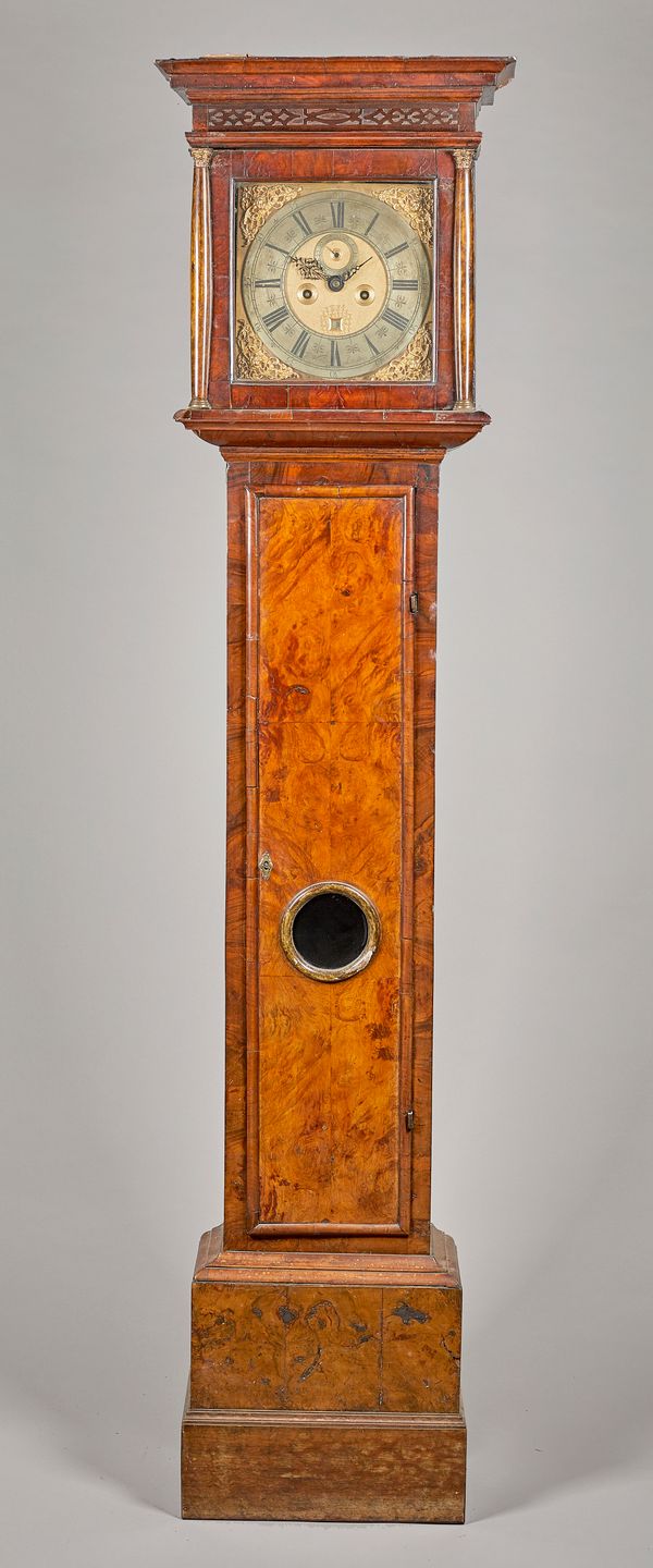 A Queen Anne walnut longcase clockBy Thomas Walkden, London, circa 1705 and laterThe hood with a moulded pediment above a blind fret, with glazed hing