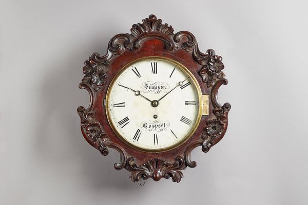 A Victorian mahogany dial timepieceBy Simpson, Gosport, circa 1865The carved shaped dial surround with a glazed brass bezel, the 8in. white-painted di