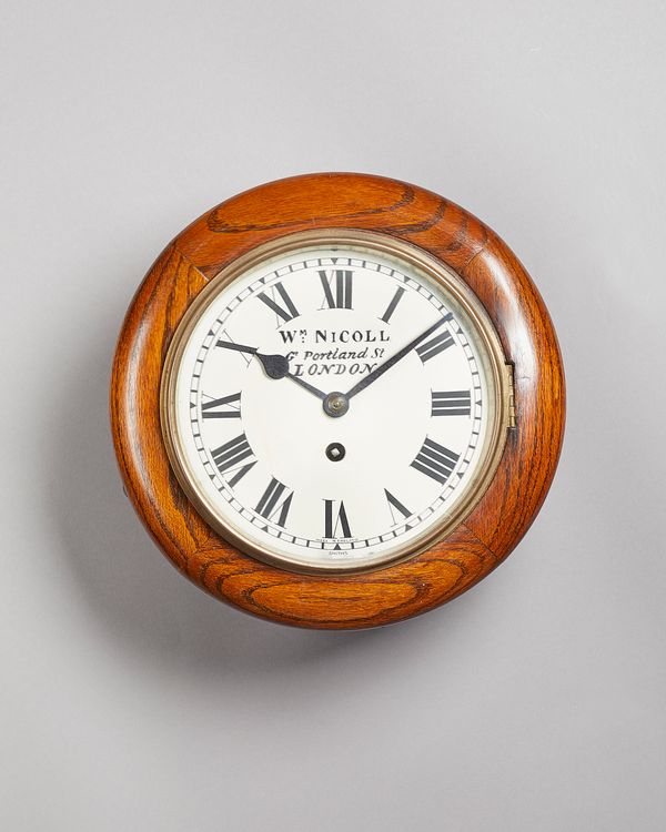 An oak dial clockBy Smiths, for William Nicoll, Great Portland Street, London, circa 1920The 8in. circular white-painted dial with blued steel spade h
