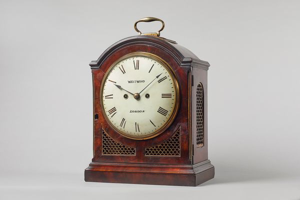 A George III gilt-brass-mounted mahogany bracket clockBy Westwood, London, circa 1790The case with a single pad top and brass carrying handle, with ci