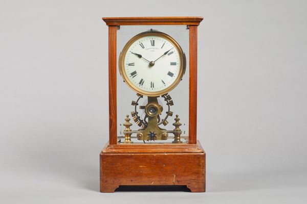 A Walnut cased Eureka electric timepieceNo. 7077, Dated 1906In a rectangular five bevelled glazed panel case, on plinth base, stamped to the reverse e