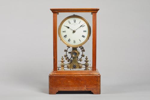 A Walnut cased Eureka electric timepieceNo. 7077, Dated 1906In a rectangular five bevelled glazed panel case, on plinth base, stamped to the reverse e
