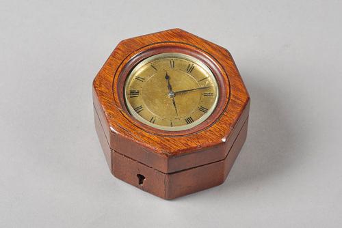 A small mahogany cased brass alarm timepiece19th CenturyThe drum-shaped movement No. 1703 with lever escapement, the gilt dial with black-painted Roma