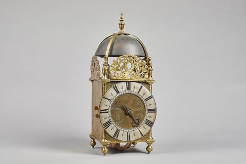 A brass lantern clockBy Henry Lintott, Farnham, 18th Century and with later elementsSurmounted by a bell, with four straps and five turned finials, th