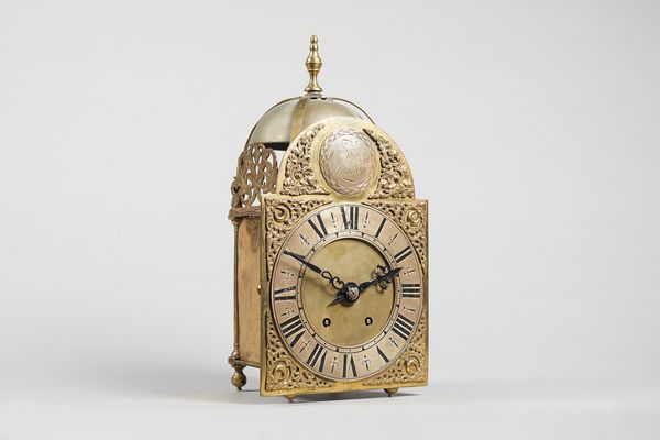 A brass lantern clockInscribed William Kipling, LondonSurmounted by a finial and bell, above the 8 in. arched brass dial inscribed to the roundel in t