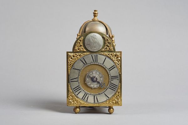 A George III lantern timepiece alarmSurmounted by a bell and five turned finials, with 4 1/4in. arched brass dial, silvered chapter ring, brass spandr
