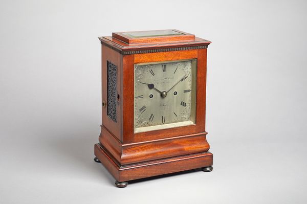 A Victorian mahogany mantel clockBy James McCabe, London, No. 2519The case with a stepped pediment inset with a bevelled glass plate above overhanging