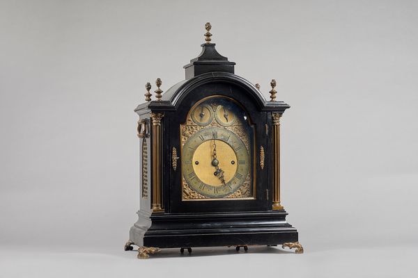 A late Victorian giltmetal-mounted ebonised three train quarter-chiming mantel clockCirca 1890The broken arched case surmounted by a stepped plinth an