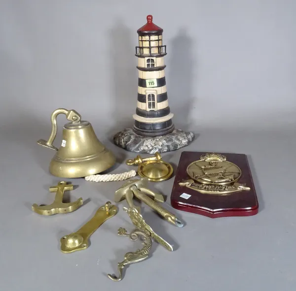 A 20th century cast iron door stop formed as a lighthouse, 63cm high and a group of brass ware of nautical interest, (qty).   S3M