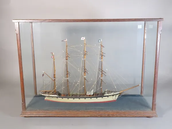 An early 20th century scratch built model of a three masted ship, in a glazed oak box, 59cm wide.  A5
