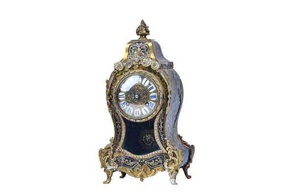 A French Boulle work mantel clock, 19th century, with foliate finial over a waisted case with enamel numerals and glazed pendulum aperture enclosing a