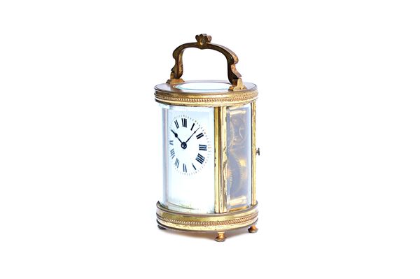 A French brass cylinder carriage timepiece, late 19th century, with visible escapement, white enamel dial and single train movement, 12cm high. Illust