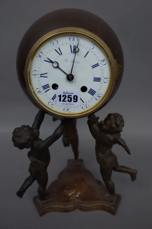 A French bronze mantel clock, late 19th century, the spherical case with enamel dial held aloft by three angel figures (33cm high), a Japanned mantel