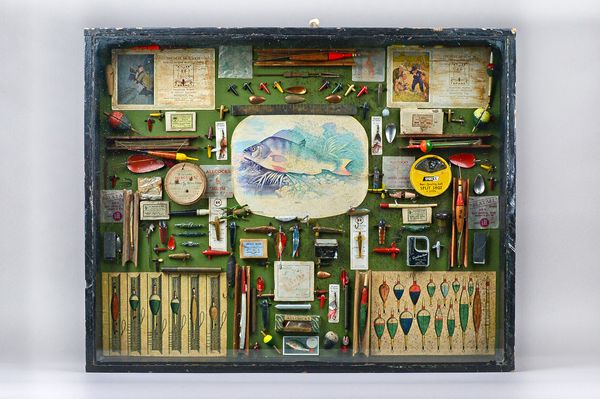 A quantity of vintage fishing tackle, lures, weights, line and related items, framed as one in a glazed ebonised display case, 80cm x 64cm x 9cm.  Ill