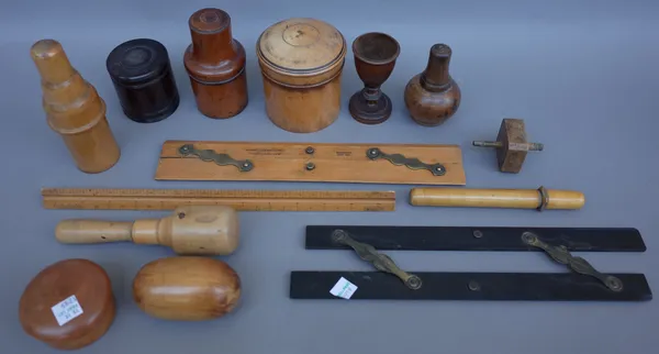 A quantity of treen collectables including; fruitwood boot templates (size 10 1/2), a circular bread board, a turned fruitwood pestle (16.5cm), an ebo