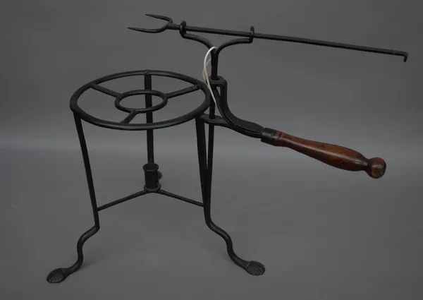 A rare late 18th century wrought iron toasting trivet, with adjustable two prong fork over a circular triform base, the legs united by stretchers with