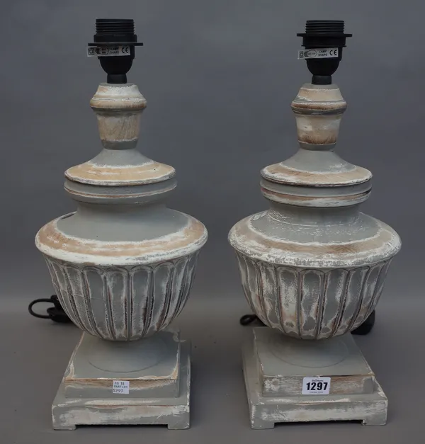 A pair of modern grey/distressed wooden table lamps, of classical, fluted urn form (37cm high) and a modern urn form composite table lamp (44cm), (3).