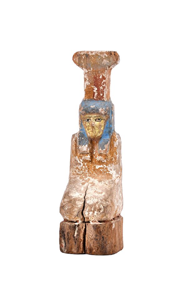 An Egyptian carved wooden funerary figure with polychrome remnants of painted decoration, 31cm high. Illustrated