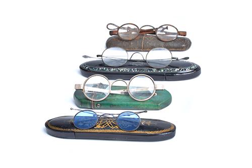 A George III pair of silver spectacles in a shagreen covered hinged case, London 1792, with short arms and pierced tips and three further pairs of ste