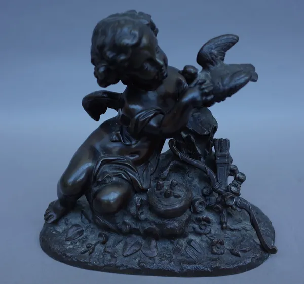 A Continental bronze figure, late 19th century, depicting Cupid and a dove over a nest of chicks, on a naturalistic rocky base, 17cm high.