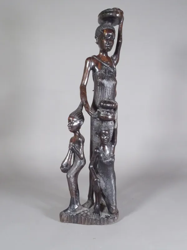 A 20th century hardwood African figure of a lady and two children, 60cm high.  CAB