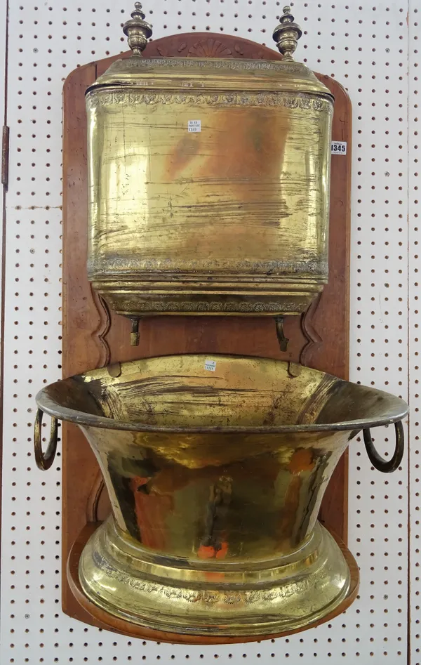 A French walnut and brass mounted water cistern, early 20th century, with carved wall mounted bracket and foliate embossed detail to brass, wall brack