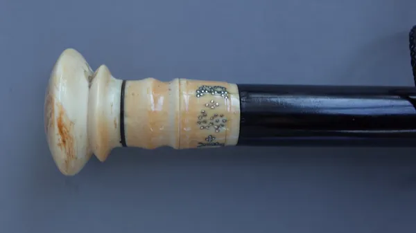 A 18th century and later ivory topped ebony walking cane, the turned ivory pommel with later pique work initials 'J.S.B', 89cm.